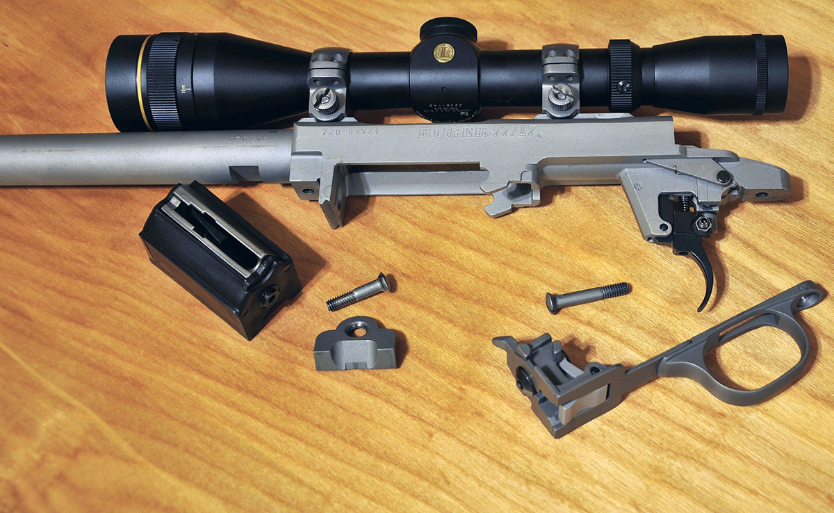 The Ruger 77/17 trigger guard hooks into two rounded mortises at the midpoint of the receiver, and the smaller front plate wedges to the receiver’s recoil lug.